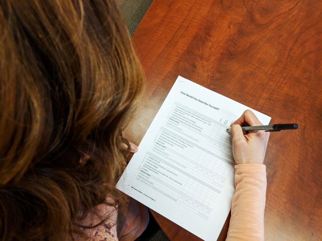 a woman taking an emotional intelligence paper assesment